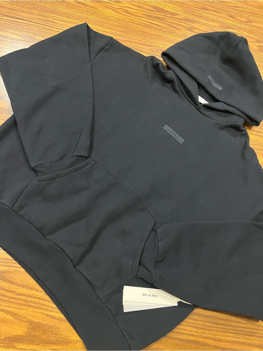 Fear of God Essentials Black with metallic print at the back